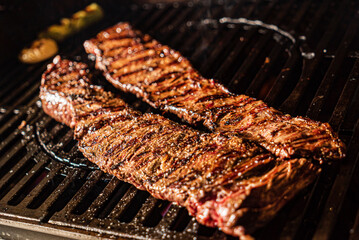 grilled meat over flaming grill