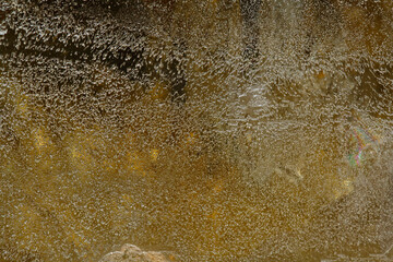 Natural luxury colorful background. A cut of a semi-precious stone. The texture of the mineral. Bubbles in resin. Multicolored. Fantastic beauty crystal. Material for jewelers and sculptors. Quartz