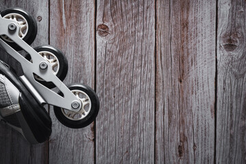 Inline skates on wooden background. Roller. Copy space. Selective focus.