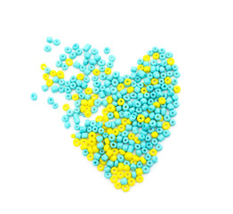 Yellow and blue beads in the form of heart.