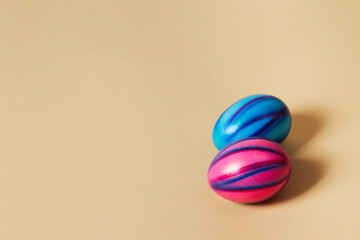 Colorful Easter eggs with on a solid beige background.  Preparation for holiday.
