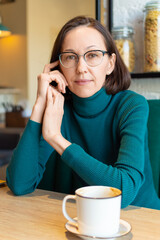Portrait of beutiful woman relaxing in a coffee shop.