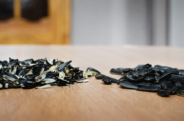 Sunflower seeds and seed husks lies on the table. Close-up, selective focus.
