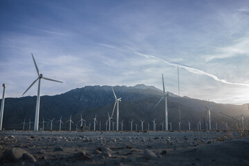 Windmills in front of a hill 