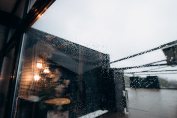 Fototapeta na wymiar wet window with drops on the glass on a rainy day