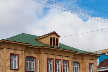 The roof of a wooden building in rich colors in the north of Russia
