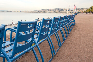 The blue chairs on the Promenade des Anglais in Nice, France - obrazy, fototapety, plakaty
