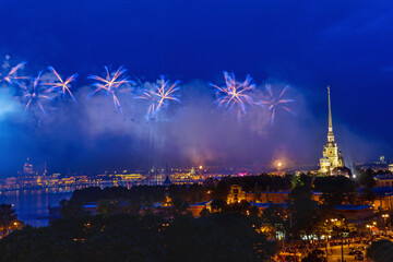 Colorful salute in the sky of St. Petersburg against the background of the night city.