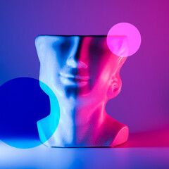 Cut stone head on the neon illuminated background and illustration circles. Glitch art geometric...