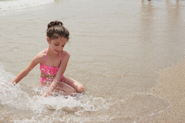 Girl playing happily on the shore of the beach, Vera, Spain