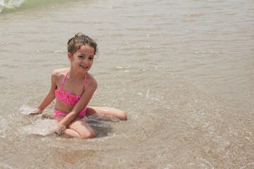 Girl playing happily on the shore of the beach, Vera, Spain