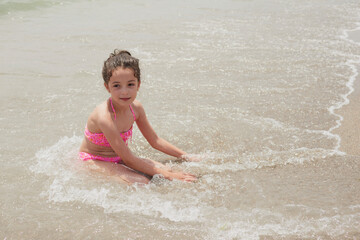 Girl playing happily on the shore of the beach, Vera, Spain