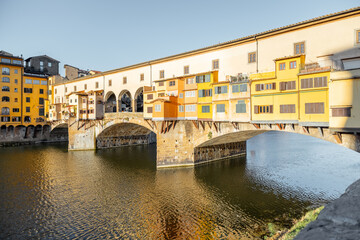 Fototapeta na wymiar Morning view on famous Old bridge called Ponte Vecchio on Arno river in Florence, Italy. Concept of traveling Italy and visiting italian landmarks