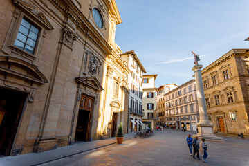Fototapeta na wymiar Morning view on Piazza Santa Trinita, triangular square, and church in Florence city. Travel italian cities of Tuscany. Italian Renaissance architecture