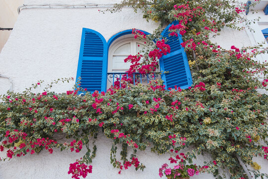 Balcony decorated with flowers on a street in Mojacar, Spain