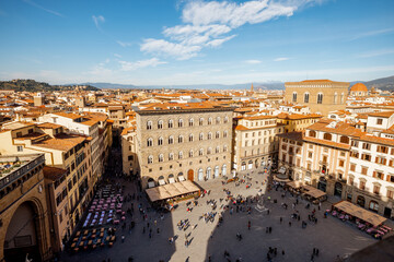 Top view on crowded Signoria square near Vecchio palace on a sunny day in Florence, Italy. Cityscape of most significant city of Tuscany