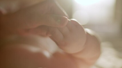 Close Up Footage of Newborn Baby Playing With Mother's Hand and Finger while Lying on the Back in Child Crib. Caucasian Neonate Toddler Bodning with Mom. Concept of Childhood, New Llife and Parenthood