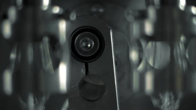 The work of mechanisms and the pendulum of the machine for weaving ropes and cords. Close-up. Macro.