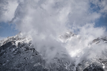 Very cloudy sky over mountains covered with snow near the alps