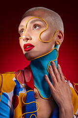 I like a little more of this and that. Studio shot of a stylish young woman posing against a red...