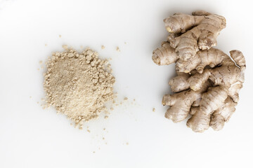 Heap of dried ginger powder and fresh ginger. Isolated on white background. Top view.