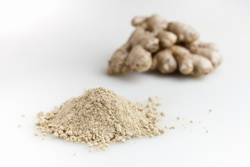 Heap of dried ginger powder and fresh ginger. Isolated on white background.