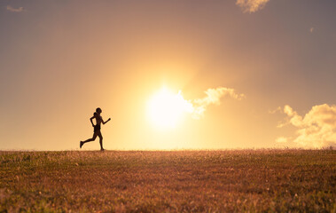 Obraz na płótnie Canvas Female silhouette running early morning 