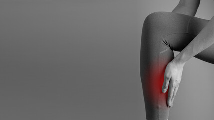 Banner with shin splints. Woman suffering from pain in leg with red spot closeup. Injury, medial tibial stress syndrome. Health care, orthopedic problems and medicine concept. Copy space. photo - obrazy, fototapety, plakaty