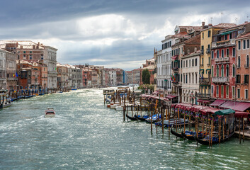 Rainy weather in Venice, water channels along residential buildings against a dramatic sky