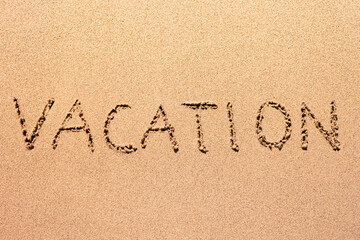 Vacation written on the sand 