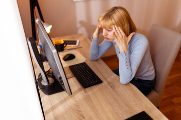 Woman working in an office having a headache