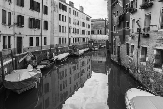 black and white photo of canal and old architecture in Venice, Italy 