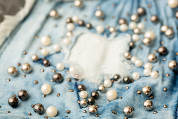 Jeans background clothing. Denim fabric closeup. Textures of clothing made of fabric with fashionable embroidery of pearl beads. Copy space for text. Fashionable style.