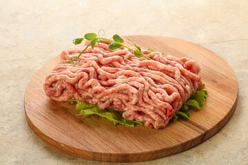 Raw minced pork meat over board