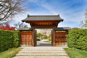 Obraz premium Freiburg, Germany - April 2022: Entrance gate of Japanese garden in public park called 'Seepark'