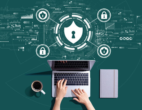 Cyber security theme with person using a laptop computer