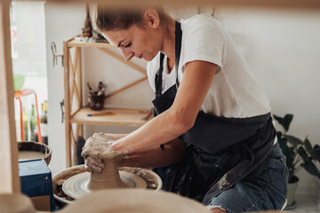 Potter Master at Work, Young Caucasian Woman Creating Clay Pot on a Pottery Wheel in Her Studio