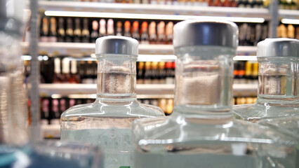 Close-up of beautiful bottles of gin or vodka on a store shelf