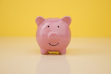 Piggy bank on yellow background. Investmenst and saving money concept