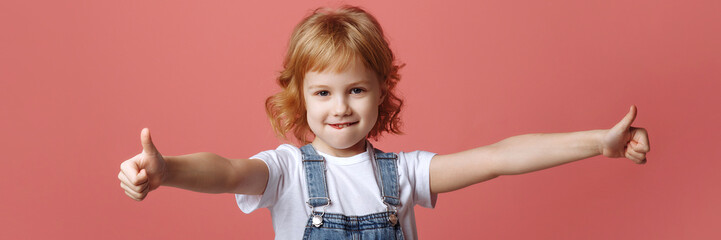 Banner cheerful little girl jumping on a pink background.