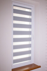 Window roller duo system day and night. Close up on roll curtains indoor.