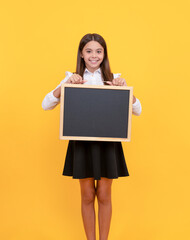 happy teen girl hold blackboard. child advertising. back to school. presenting novelty information