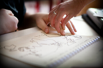 A blind or visually impaired pupil revises the maps in relief to pass.