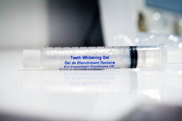 Teeth whitening by applying a gel in a tray and exposure to an LED.