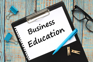business education. text on paper in folder on blue wooden background