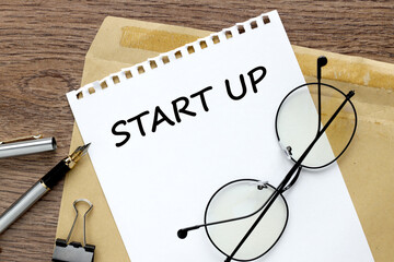 Start Up text on paper on an envelope