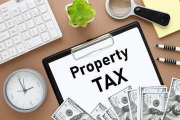 Property Tax test on white paper on a black folder on a brown background