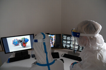 Two doctors examine the results of a patient with covid-19.