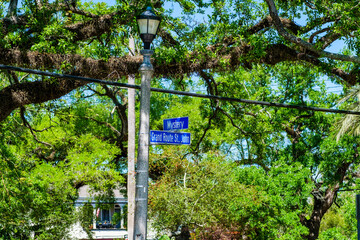 Mystery Street and Grand Route St. John Street Signs on Lamp Post in New Orleans, LA, USA