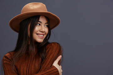young woman brown hat hand gestures brown sweater fashion emotions isolated background